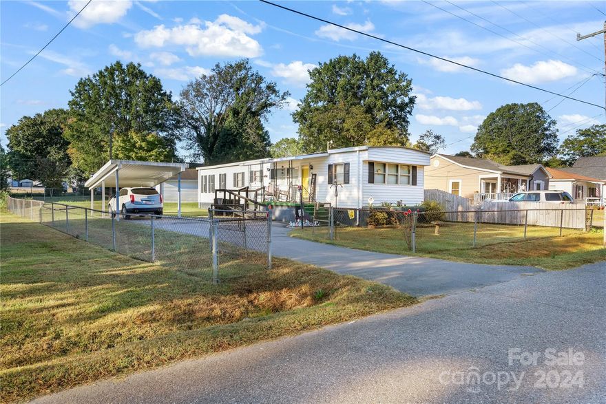 Welcome to this charming home in the heart of Concord, NC, perfectly situated near shopping and dining. Located very close to Highway 601 and Highway 29. This well-maintained residence features 3 bedrooms and 2 full bathrooms, with carpet and linoleum flooring that was updated just 5 years ago. The primary bedroom boasts elegant wainscoting, adding a custom touch! The open-concept kitchen and living room create a warm and inviting feel, ideal for gatherings with family and friends. Step outside to a generously sized covered porch, perfect for enjoying your morning coffee or hosting weekend barbecues. The property also includes detached covered parking & the property is fully fenced. With its spacious lot, this home is truly an entertainer’s dream, providing ample space for events and cherished moments with loved ones. Don’t miss the opportunity to make this lovely house your home!