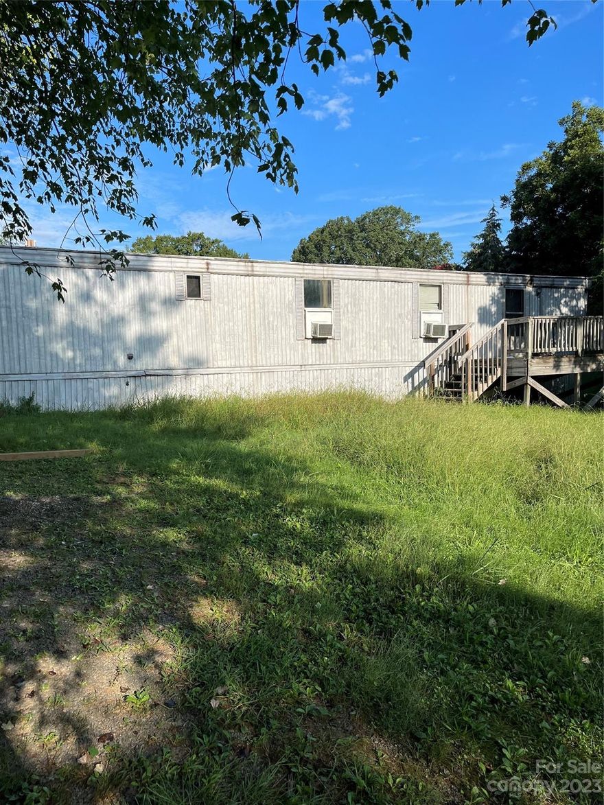 Singlewide mobile home available in the Western Stanly area!  Home sits on just under an acre.  2 bedrooms and 1 bath.  According to the tax records the trailer is from 1984.  30 x 20 detached workshop needs some TLC along with the singlewide.  Beautiful views of the countryside from the front yard.  Mobile home is sold AS-IS.