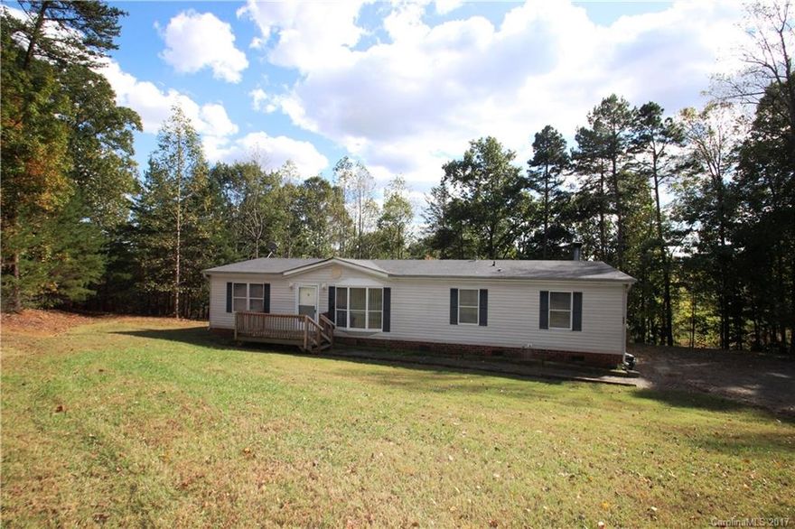 Move in Ready on 2 Acres.  This 3 bedroom 2 bath has new interior paint, new carpet in the bedrooms and all new light fixtures/ceiling fans.  New ceramic tile in the kitchen and laundry.  New laminate wood flooring in the living room, dining area and den areas.  Wood burning fireplace in the den with built in shelving.  Very private deck that overlooks a wooded backyard.