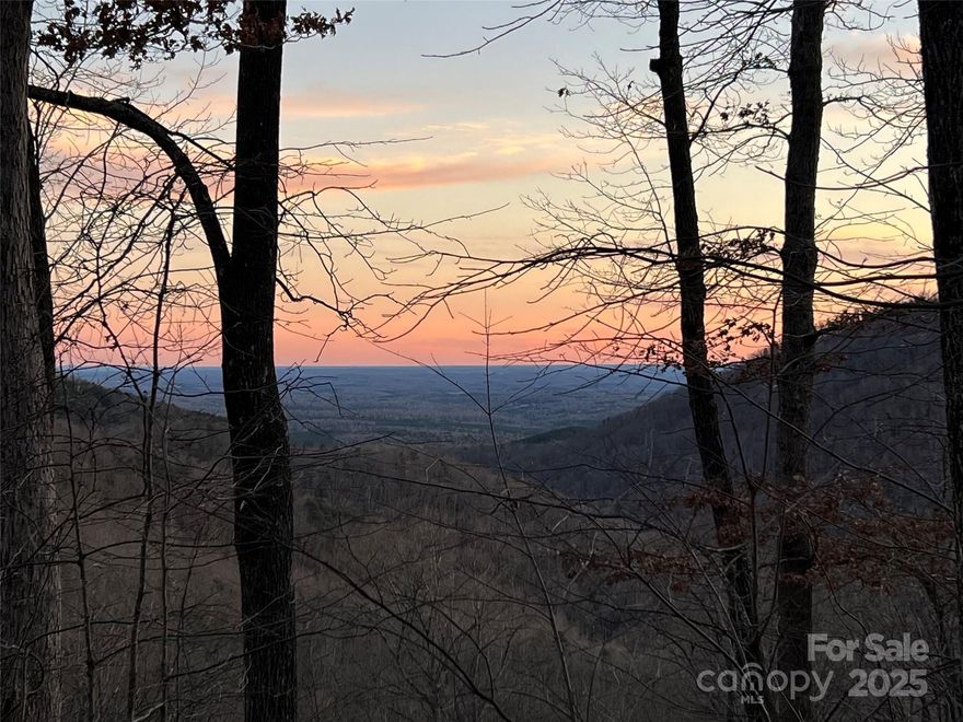 Exceptional long-range views w/southerly exposure, making it a prime location to build a home w/stunning vistas. Being situated in the Great Sky community provides privacy & a peaceful setting while still offering convenient access to major cities like Asheville, Greenville/Spartanburg, & Charlotte. Proximity to Chimney Rock State Park & South MTN. State Park adds plenty of outdoor options, & attractions like Lake Lure & Chimney Rock are just a short distance away, making this an ideal spot for nature lovers & those seeking a quiet mountain retreat. The corner lot adds additional appeal, allowing for a custom home that takes full advantage of the expansive views.