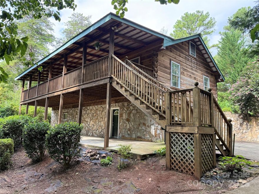 Retreat, anyone? Located in the equestrian paradise of Tryon, NC, we invite you to take a look at this must-see property! Live every day tucked away completely out of sight on 2.28 acres with privacy galore, gorgeous mature trees and lush established landscaping all around. Perched up in the middle of it all is this custom-built log cabin that truly feels like a mountain getaway! It has it all. Imagine relaxing to the sounds of nature on this amazing front porch complete with tin roof (bring on the rain!) that spans the entire length of the home. A completely covered lower level that's perfect for hanging out and grilling rain or shine. The interior has an open concept main level with hardwood floors, spacious kitchen and dining area, 2 bedrooms and 2 full bathrooms on the main level. The basement offers an additional bedroom, full bathroom and a flex room. This lower level could be the perfect teen getaway, home office or a possible rental income space! If you're looking for more outdoor space, it has it. Step out onto the covered back porch and take a load off. Private and surrounded by more beautiful landscaping, mature trees and complete with an ecstatically matching workshop/planting shed that's perfect for your DIY projects or a he/she shed. You pick. Sellers are offering a 1 YEAR HOME WARRANTY! Interested yet? A short 10 minutes from Tryon International Equestrian Center, a local winery just down the road and less than an hour to Asheville! Welcome home!