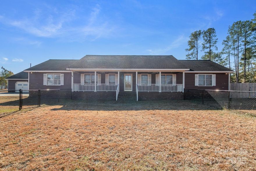 Welcome home to this inviting 3-bedroom, 2-bath home situated on over an acre in a quiet, convenient Cheraw location. Enjoy a spacious fenced yard with both single-gate and double-gate access for pets, equipment, or outdoor projects. The property includes an oversized 40×50 garage with 110/220 power and vehicle lifts—for a mechanic or hobbyist and a two-car attached carport. Energy efficiency shines with paid-off solar panels, keeping average electric bills under  per month. Inside, the home has an open layout, abundant natural light, and comfortable living spaces. A blend of privacy, practicality, and location and just minutes from town conveniences.