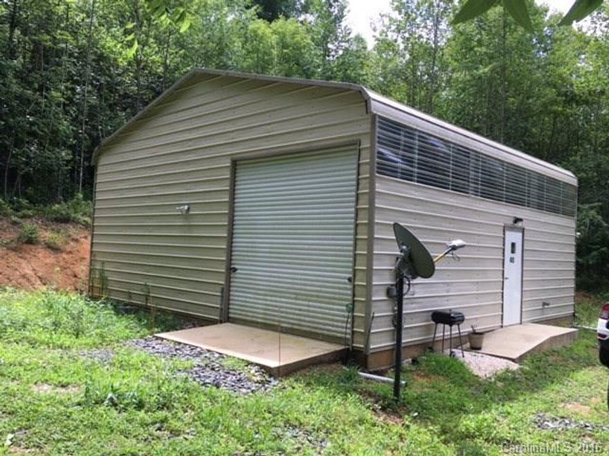 Awesome South Toe Valley tract with a private location and incredible views of the Black Mountain Range! 30'x30' steel garage building in a nice clearing has a 500 sq.ft. efficiency apartment ready to be customized to your needs while building your dream home on this land, with numerous house sites to choose from! Private well and 3BR Septic approval. Spring water system with reservoir and pump, two springs, lovely woods, nice privacy and end of the road! Won't last long!