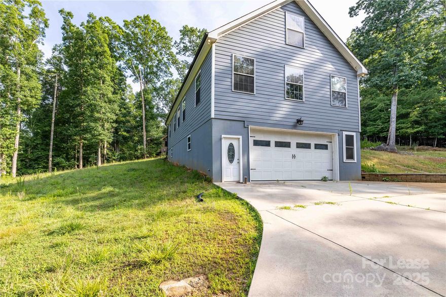 Beautiful 3 bedroom 3 full bath home located is desirable Woodrun Gated Community which features community club house, tennis courts, outdoor pool from the pool there is a awesome view of Lake Tillery.  This home features an open floor plan living, kitchen with island, granite countertops with great counter space,  lots of cabinets for storing, plenty of natural light, 2 unique lofts, each bedroom has it's own bathroom with walk in shower. This home is definitely a must see. The home is equipped with a Hugh garage on main level access to the home is through the garage or around back to enter on the upper level. Don't miss this opportunity schedule your showing today.