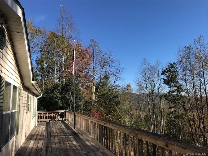 Great location in Little River. Well kept double wide manufactured home with carport and outbuilding. Wired with back up generator.  Large deck to enjoy the distance mountain views, walk way ramp onto deck. Plenty of space to garden and enjoy the private setting on this 3 acre parcel. Small creek beside house adds to the charm of this setting. Roof replaced in 2005. Gravel and paved access with as needed POA fees. Idea location in Transylvania county and close to all our great area has to offer!