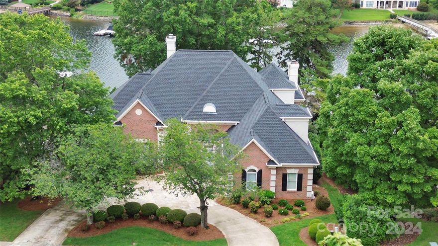 Welcome home to a stunning waterfront property nestled in the sought-after neighborhood of The Peninsula on Lake Norman. This impressive home boasts 5 bedrooms, 4.5 bathrooms, and a spacious 6066 square feet of living space. Upon entering, you'll be greeted by an elegant interior featuring high ceilings, abundant natural light, and breathtaking water views that create a serene ambiance throughout. The main level offers a seamless flow between the living spaces, including a gourmet kitchen, formal dining room, and a cozy living area with a fireplace. The primary suite is a true retreat, complete with its own private space and a luxurious ensuite bathroom. Additionally, the home features a full basement, ideal for entertaining or creating a private sanctuary. Step outside to the patio and savor the captivating water views while enjoying the peaceful surroundings.Don't miss the opportunity to make this exceptional waterfront property your own and experience the epitome of lakeside living.