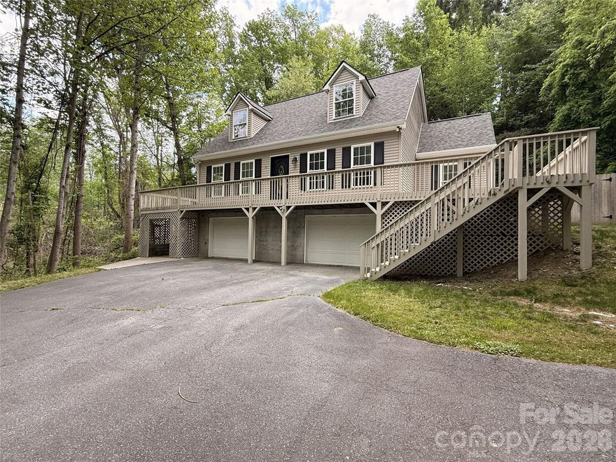 Welcome to the perfect blend of warmth, function, and location—set on a generous 0.84-acre lot in one of Arden’s most convenient areas. This inviting home features an open floor plan anchored by a spacious living room with a rock-accented fireplace and wet bar, ideal for entertaining or relaxing evenings at home. Thoughtful features include a large walk-in pantry, main-level laundry, and an easy, functional layout. Enjoy the outdoors from the partial wraparound deck overlooking the fully fenced, private backyard—perfect for gatherings or quiet mornings. The main-level primary suite offers a peaceful retreat with direct access to the deck, an en suite bath, and a generous walk-in closet. A two-car garage provides ample storage, while the expansive bonus room offers flexible space for a home office, gym, or guest area. Ideally located just minutes from Biltmore Park, Hendersonville, and Asheville Regional Airport, this home combines privacy with everyday convenience near dining, shopping, and outdoor recreation.