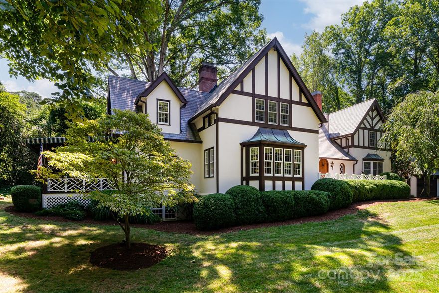 This charming 1923 English Tudor home nestled on 1.8 acres in the coveted town of Biltmore Forest, is brimming with curb appeal and ideally set across from Rosebank Park. Featuring 6 bedrooms and 5 full bathrooms and a private yard with room to play, this residence offers remarkable flexibility. At the heart of the home is a large living room with a fireplace perfect for gatherings and relaxation. The sitting room and office, just off the living room, could be re-imagined into a sizeable primary suite on the main level if desired. Its quaint and tasteful kitchen is open to a breakfast area and steps away from a formal dining room. The upper level boasts 4 en-suite bedrooms including a spacious primary bedroom, providing ample room for family and guests. The Lower level family room wrapped in unique wormy chestnut walls features a 2nd fireplace and wet bar creating a cozy vibe- ideal for entertaining. Own a piece of history by making one of Biltmore Forest's original homes your own!