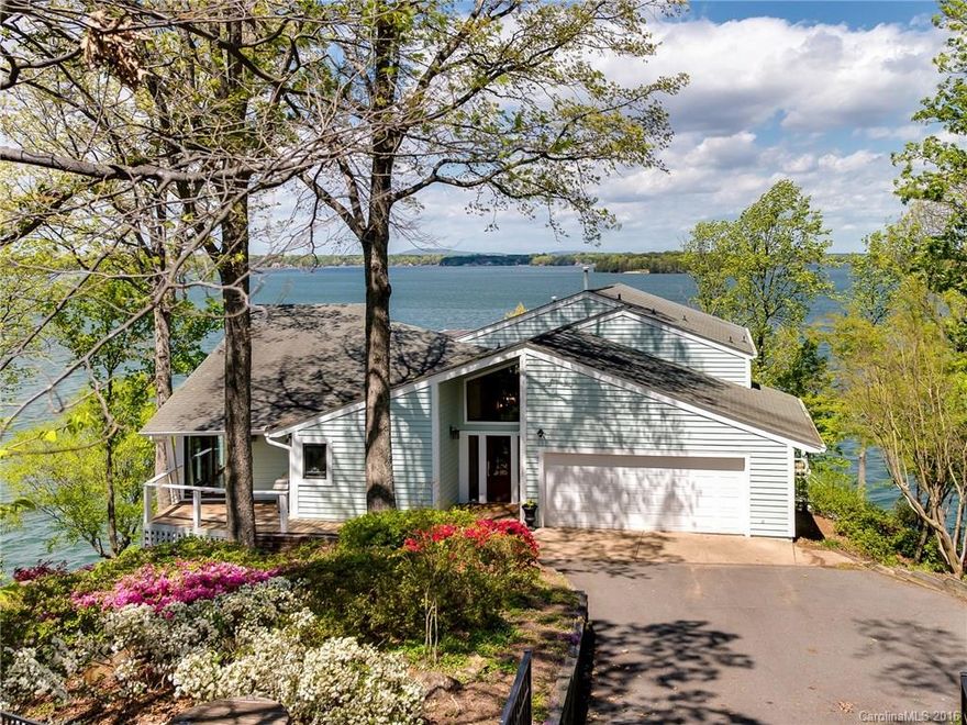 Stylish “coastal modern” makeover brings a new look to this landmark cottage crowning one of the highest points on Lake Norman.  424 ft of point-lot shoreline w/180 degree breathtaking views, this property is wrapped with a huge boardwalk which lays at its feet.  New lighting & soaring ceilings give this one of a kind an airy feel. Gourmet kitchen features stainless appliances, industrial sink & quartz counter tops.  Lower level bath complete w/quartz counters, seamless shower & the latest tile.