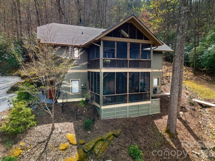 Discover a meticulously maintained sanctuary set on 2.38 private acres, bordered by two babbling creeks in the highly sought-after Glen Cannon community. Perfectly positioned just minutes from Downtown Brevard and the entrance of Pisgah National Forest, this home is the ideal launchpad for mountain biking, hiking, and trout fishing enthusiasts.

Step inside a main level that floods with natural light, offering the serene feel of living in the treetops. The open-concept interior features vaulted ceilings and expansive windows. The renovated primary suite is a true sanctuary, featuring a spa-like walk-in shower, custom storage, and heated tile floors. The chef’s kitchen is designed for entertaining, flowing effortlessly into the dining space and living area anchored by an inviting fireplace.

The real showstopper? The Treetop Screened Deck. Experience mountain living on a massive scale, upgraded with a brand-new 50-year shingle roof, new skylights, and remote-controlled shades for year-round comfort.

The flexible lower level offers a third bedroom, full bath, and versatile flex space—perfect for a home office, guest suite, or recreation room. Plus, the oversized 2-car garage provides ample storage for kayaks, bikes, and all your outdoor gear.

Experience the peace of the mountains with the convenience of Brevard at your doorstep. This is one you truly have to see!