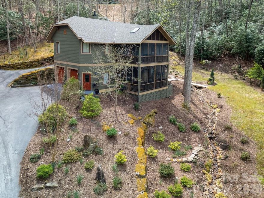 Experience the ultimate mountain retreat in the highly sought-after Glen Cannon community. Set on 2.38 private acres and bordered by two babbling creeks, this meticulously maintained 3-bedroom, 3-bath home serves as the perfect Brevard basecamp for outdoor enthusiasts. Inside, you are greeted by vaulted ceilings and an abundance of natural light that highlights the open-concept living area and chef’s kitchen. The renovated primary suite is conveniently located on the main level, offering a luxurious sanctuary with easy accessibility. One of the home’s standout features is the massive screened deck, complete with a brand-new 50-year shingle roof, new skylights, and remote-controlled shades that allow you to live among the treetops in total comfort. The finished lower level provides exceptional flexibility, featuring a third bedroom, full bath, and a dedicated flex space—ideal for a home office, guest suite, or the ultimate mountain bike and gear room. Complete with an oversized 2-car garage for your kayaks and gear, this property is located just minutes from Downtown Brevard and the gates of Pisgah National Forest, offering immediate access to world-class hiking, waterfalls, and trout streams.