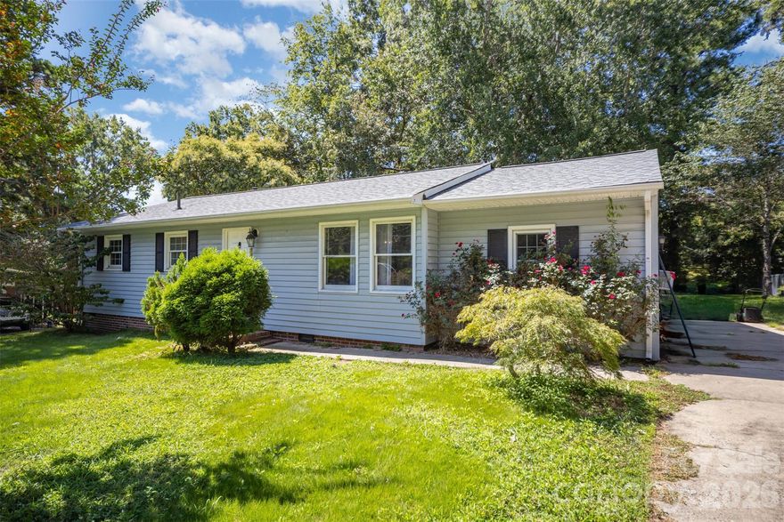 Situated on a spacious, tree-filled lot in Mount Holly, this charming home offers a rare combination of yard space, privacy, and convenience. Set on nearly a third of an acre, the property is surrounded by mature trees that provide shade and a peaceful setting while still being just minutes from everything the area has to offer.
The home features a comfortable single-level layout with inviting living spaces and plenty of natural light throughout. A large living room and adjoining dining area create a welcoming place to gather, while the kitchen opens easily into the main living areas for everyday functionality. Additional flexible spaces within the home offer room for a den, office, or hobby area depending on your needs.
One of the standout features is the expansive backyard. The large lot offers endless possibilities with plenty of room for outdoor entertaining, gardening, pets, or future improvements. A deck off the back of the home provides a great place to relax and enjoy the surrounding greenery, while the open yard and mature trees create a quiet, park-like atmosphere.
Located just minutes from historic downtown Mount Holly, the home provides quick access to local restaurants, shops, parks, and community events. Outdoor enthusiasts will enjoy the close proximity to the U.S. National Whitewater Center and the charming town of Belmont, while nearby highways make commuting to Charlotte and surrounding areas simple. This property offers a great opportunity to enjoy a larger lot and peaceful setting while staying close to all the conveniences of the area.
