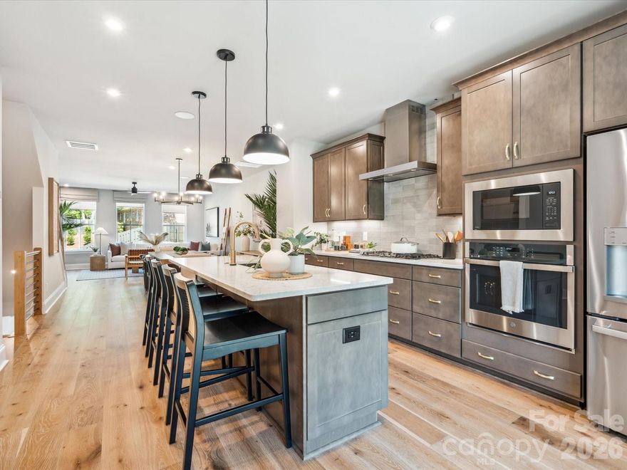 Set within the charming streets of Old Town Village, 436 Old Town Village Rd offers three stories of thoughtfully planned living just a short walk from downtown Waxhaw. The first floor welcomes you with a private third bedroom and full bath, ideal for guests, a home office, or a quiet retreat. Oak box stairs with open rail details set a light, airy tone as you move through the home, while covered outdoor living extends your everyday space and invites relaxed mornings and easy evenings. The heart of the home unfolds on the main living level, where a gourmet kitchen anchors daily life with warm brown cabinetry, white quartz countertops, a gas cooktop, and a spacious island featuring a large sink with a Delta Essa touch faucet. Upstairs, the primary suite feels calm and refined with a beautifully finished bath showcasing tiled shower walls and a tiled floor pan. Low-maintenance living, tree-lined streets, and close proximity to shops, dining, and historic downtown Waxhaw make this home an ideal blend of comfort, convenience, and timeless neighborhood appeal.