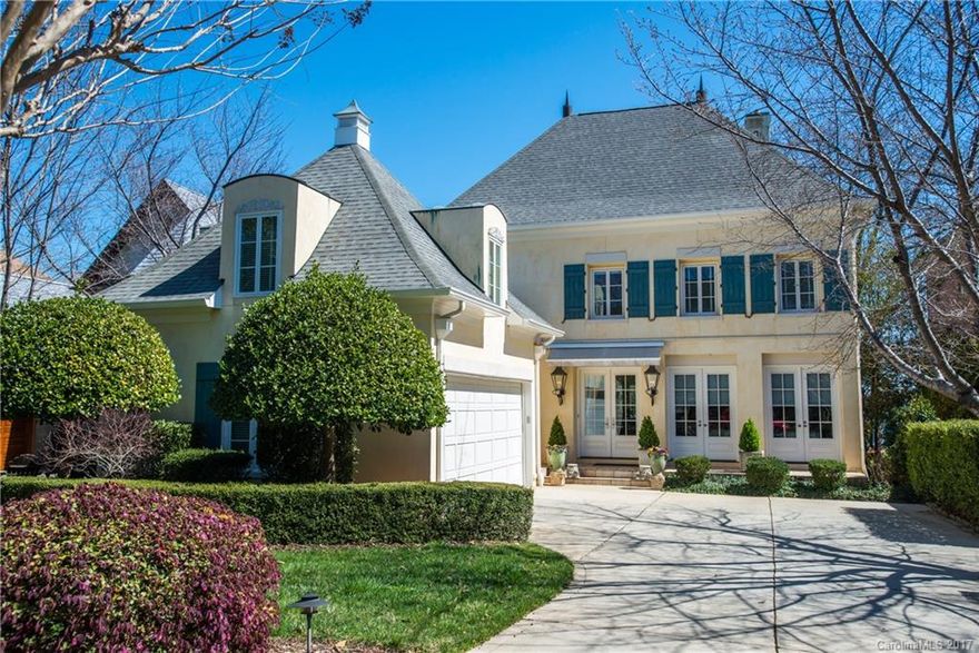 Beautiful French Country design on the water in The Peninsula.  Don't miss this meticulously designed and crafted custom home with amazing year round water, no shallow cove here!  Home has generous master on the main and a very open floor plan.  Kitchen, dining and sunroom all adjoin openly for entertaining.  The rear covered porch and lower entertainment patio are light and airy for total enjoyment of lake living!  Shared dock with only one neighbor and the boat lift remains.  Immaculate home!