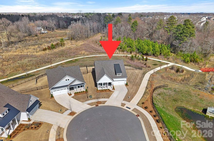 Pickleball~Pool/Spa~WalkingTrails~Dog Park! These just are a few of the resort-style amenities to enjoy at this premier 55+ community Esplanade at Northgate. Designed with model home finishes, 406 Portrait Way is BETTER THAN NEW (Built in 2023) ideally located on PREMIUM Cul-de-Sac Lot with beautiful unobstructed VIEWS of Nature! The Backyard Outdoor Living Area, featuring a Covered Porch and fully fenced yard are WOW! Sellers attention to modern touches & space appeal is exactly what you will find here. You are greeted by a rocking chair front porch that leads into spacious Foyer, you will immediately be captivated by the Trey Ceiling Foyer. Main level has dramatic 10' ceilings and wood LVP flooring throughout. Front of home has Guest Suite with Full Bath, featuring Quartz Vanity & Seamless walk in Shower! Do not miss the Private home office or study with French doors & Custom wallpaper accent wall, even has Ethernet connections. Incredible Gourmet Kitchen Features all the modern touches todays Buyers Expect; 5-burner Gas stove, updated Stainless steel appliances, Tongue & groove soft close Cabinetry, Expanded Quartz Island offers extra Storage & wine rack, Custom Tile Backsplash & Generous walk in Pantry! The island offer plenty of room for entertaining. Adjoining is the Eat in Breakfast Area which allows for casual dining. The heart of this home is the Inviting Great Room featuring central gas log Fireplace, accented by a "wall of Windows" brings so much natural light! Spacious & Private Primary Ensuite Bedroom features Tray Ceiling & ceiling fan. STUNNING Primary bathroom features Quartz double-sink vanity, tiled floors and 8 Ft Walk in Shower w/ dual shower heads and spacious walk-in Closet! On the upper level you will find a HUGE Bonus Room, perfect for challenging guests or family to a ping pong Match! An additional private guest bedroom, walk-in closet with adjoining full Bathroom, Great for guests, in-laws or Teen retreat. 
Lower-level Laundry Room with cabinetry, Half bath and Convenient drop Zone!
What makes this home so spectacular? Esplanade at Northgate is designed for connection and well being, where residents enjoy top-tier amenities: challenge friends on the pickleball courts, unwind in the sparkling pool and spa, stroll scenic walking trails, gather for bocce ball, cornhole or at the dog park Indian Trail, NC premier resort-style 55+ community featuring Premium Lot!