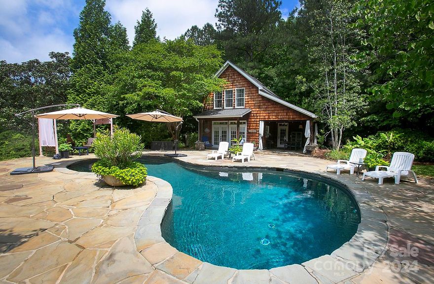 Welcome to your spectacular unicorn of a home with 2.3 acres of privacy, huge owners’ suite on the main, updated kitchen and baths, 1,035-sf ADU/guest house, luxurious heated saltwater pool, yummy outdoor kitchen, ginormous screened porch, outdoor fireplace. Great natural light beams off hardwood floors throughout. Your updated kitchen with the coolest farm sink in the world & large marble island overlooks great room featuring gas fireplace. Your 432-sf owners’ suite on the main is your private oasis. … Your backyard is a dream come true, straight out of a magazine -- pool, outdoor kitchen, outdoor fireplace (with gas igniter), 189-sf screened porch, professional landscaping with in-ground irrigation, stocked pond, garden beds, privacy. WOW! … Tons of storage -- 2 large walk-in attics + ADU storage room. … ADU generates $33,000+ annually via AirBNB. ADU furniture/appliances convey. Refrigerator & washer/dryer convey. … 8 min. to Downtown Rock Hill & Winthrop U, 30 min to Uptown CLT.