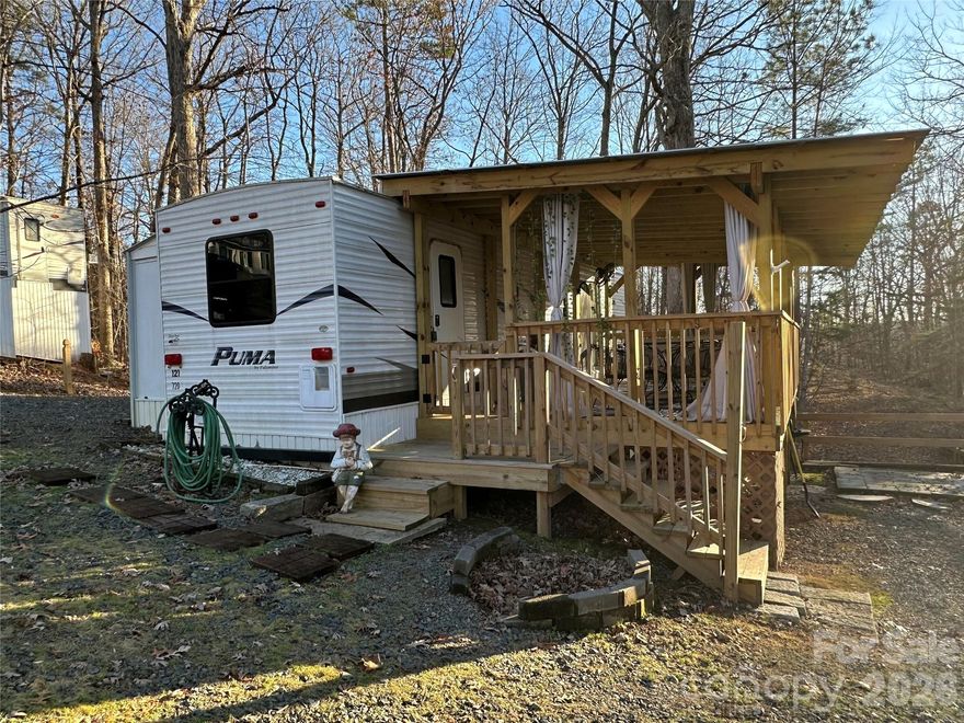 Welcome to your lake getaway, where relaxation meets nature’s beauty! This destination camper is permanently set on a deeded lot within the gated community of Badin Shores Resort, offering endless opportunities for recreation and lake living. Step inside to an open-concept living, kitchen, and dining area designed for comfort and easy entertaining. The primary bedroom features a king-size bed, while the second bedroom offers a fun bunk-style retreat—perfect for guests or family. Outside, a spacious recently covered deck is the perfect spot to enjoy alfresco dining, or simply unwind while taking in the peaceful surroundings. Situated on a cul-de-sac street, this property provides a quiet setting with minimal traffic. Badin Shores Resort offers an array of amenities including a community pool, basketball/pickleball courts, putt putt, waterfront boardwalk, playgrounds, fishing pier, stocked catch n release fishing pond, manmade sandy beach and lake swimming area, sand volley ball court and clubhouse. With the lake just a short golf cart ride away, you’ll enjoy convenient access to boating, fishing, and all the outdoor activities that make lake life so special.