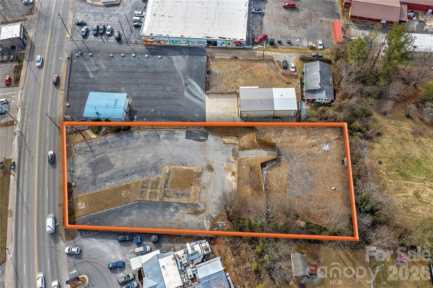 Presenting a rare opportunity to acquire vacant land along one of Asheville’s most active commercial corridors. Zoned Highway Business (HB), the property allows a wide range of potential uses including retail, office, medical, restaurant, self-storage, automotive, drive-thru (subject to review), and outdoor commercial concepts such as a food truck lot.  The site is largely ready for development with direct frontage and access from Patton Avenue, providing excellent visibility and traffic exposure. Existing paved areas and a fenced rear section enhance the property’s functionality and flexibility, offering immediate utility for staging, parking, or secure outdoor use. This is an ideal opportunity for investors, developers, or owner-users seeking a high-exposure site with strong commercial potential in West Asheville.
