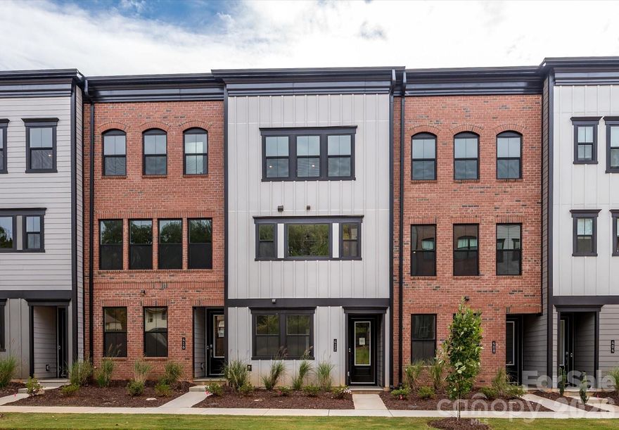 This move-in-ready home in Old Town Village is designed for bright, open living with the ease of a low-maintenance lifestyle and no exterior yard work. Sunlight fills the open layout, enhanced by open-rail details and warm oak box stairs that add character and flow. The gourmet kitchen pairs crisp white cabinetry with a richly toned island, matte black accents, and a gas cooktop, creating a space that feels both stylish and functional. Large sliding glass doors lead to a covered back porch overlooking peaceful, tree-lined views, extending the living space outdoors. A first-floor flex space offers versatility for a home office, hobby room, or guests. Upstairs, the primary suite provides a calming retreat with a spa-inspired bath, walk-in closet, and thoughtful finishes throughout. Located just moments from the charm and energy of downtown Waxhaw, this home blends comfort, convenience, and connection.
