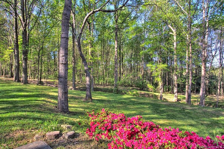 Stunning brick home in the heart of Huntersville with 3.56 acres! No HOA and a very private road and lot! This home has a 3 car garage PLUS a one car basement garage. Lots of potential with the unfinished basement for more heated square footage in the future. Enjoying the lush landscape, deck & sunporch! All windows & garage doors have been replaced along with flooring & carpet. What a serene landscape that's minutes from I-77, Lake Norman and shops!