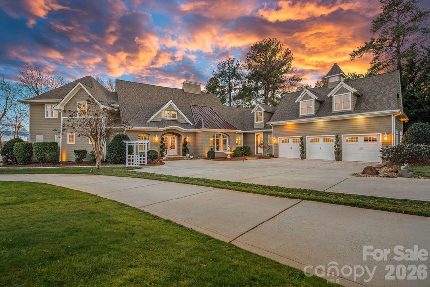 This stunning home is more than a residence... It is a refined Lake Norman retreat where craftsmanship, lifestyle, and location come together in perfect harmony. This Nantucket-inspired waterfront estate, custom built by Passarelli Custom Homes, offers over 240 feet of pristine shoreline on the desirable Brawley Peninsula, just beyond The Point, with wide, open lake views. Thoughtfully designed to capture the water, natural light, and outdoor living from nearly every room, the home feels warm and inviting yet casually elegant, with lake views from every bedroom. The main level is ideal for both everyday living and entertaining, featuring a stunning great room with custom fireplace and panoramic lake views, a gourmet chef’s kitchen with high-end Thermador stainless appliances including a professional-size refrigerator, two cabinet-faced dishwashers, wine refrigerator, and designer lighting throughout, plus a private owner’s suite with entry hall, lakeview bedroom, spa-inspired bath with walk-in shower, expansive custom closet with island, and its own dedicated laundry room. The home offers exceptional flexibility with a private office and private study, both with lake views, a loft sitting area, spacious bonus/recreation room, exercise room, additional flex space, and abundant storage throughout. Outdoor living is equally impressive, featuring an extensive paver patio, covered lakeside porch with surround sound, lakeside fireplace, outdoor kitchen, outdoor shower, and a hot tub/cold spa that conveys. A beautiful paver walkway leads to a private pier with covered 10,000 lb boat lift, providing effortless access to the water, while an exterior storage area with double doors is perfect for lake toys and gear. Additional highlights include four bedrooms, three full baths, three half baths, two laundry rooms with sinks and cabinetry, an oversized three-car garage, a drop zone and friends’ entrance with nearby half bath, Sonos surround sound, whole-home AV and Cat 5/6 wiring, Hague whole-house water filtration and purification system, alarm system with motion and glass-break detection, newer landscape lighting and plantings, exterior paint, and meticulous maintenance throughout. Ideally located just 2.5 miles from Trump National Golf Club Charlotte, with memberships available, this exceptional property delivers privacy, freedom from HOA dues, and an unparalleled Lake Norman lifestyle.
