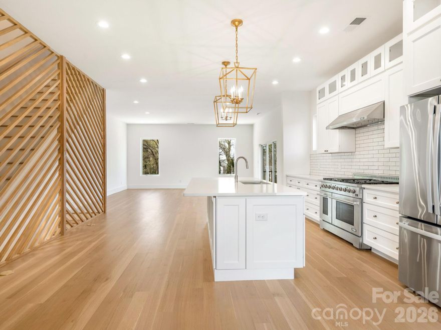 Discover the charm of this modern townhome in Five Points, just minutes from Center City Charlotte. This 3-bedroom, 3.5-bath home boasts 10-foot ceilings, a spacious 2-car garage, and an expansive 900-square-foot rooftop terrace perfect for entertaining or stargazing.

Inside, high-end finishes include soft-close shaker cabinets, a 48-inch gas range, quartz countertops, and solid white oak hardwood floors, complemented by an artistic geometric wood wall. The open-concept design encourages connection, while the primary suite offers a luxurious walk-in shower and a custom closet.

Outside, enjoy a private retreat with a stylish stone-tile retaining wall and wooden privacy fence—ideal for relaxation and gatherings. Located just one block from the Gold Line Streetcar and with easy access to major roads, this home perfectly combines luxury, style, and convenience. Experience modern urban living at its finest!