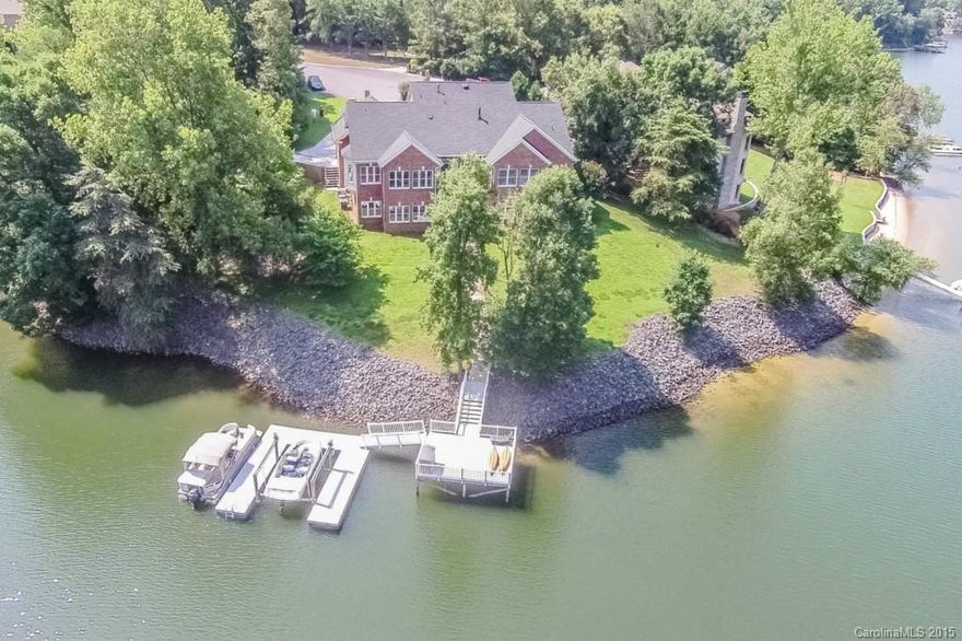 Elegant Southern Lake Living!  300 ft of waterfront nestled at the tip of a wide cove w/gorgeous views, deep water, gradual steps to dock & water, award winning schools, & minutes to the airport & Uptown!  Main Level Master & Guest Suites. Spacious flowing lower level for perfect entertaining or full 2nd living qtrs. Every detail carefully crafted for quality & low maintenance from extensive granite to Zoysia sod to the 1000 ft dock w/ vinyl decking & rails & remote controlled lift!
