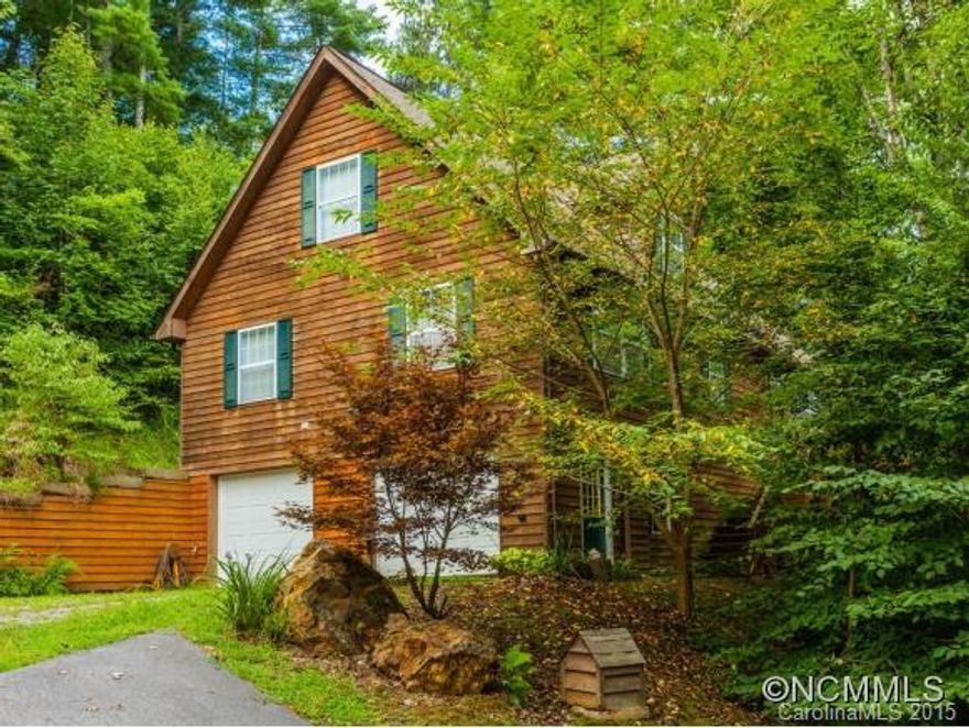 Beautiful, private cabin w/ cedar siding just north of downtown Weaverville!Enjoy the serenity of the country and convenience of being close to all Asheville has to offer! This lovely home is filled of natural light, beautiful corian countertops,a home theater, 2 master suites, an office nook in the kitchen, wraparound deck with an adjoining level yard in the rear. Homes in this community have large lots and are not on top of one another!