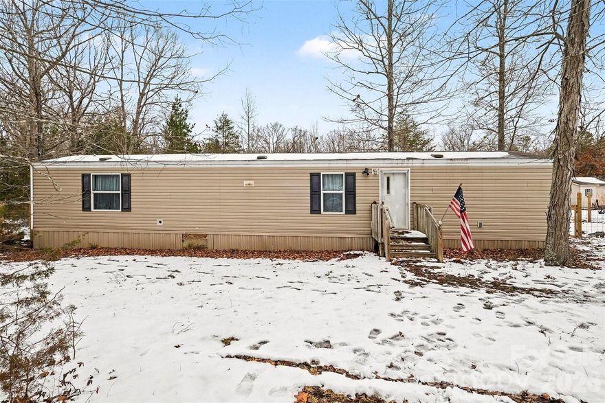 Tucked away on a peaceful one-acre homesite in York, this charming 2019 manufactured home offers a wonderful opportunity for comfortable country living with modern conveniences. Surrounded by mature trees and set on a level, partially fenced lot, the setting provides both privacy and space to enjoy the outdoors. Inside, the home features an inviting open layout with vinyl plank flooring throughout and a spacious living area that flows easily into the kitchen. The kitchen is well-equipped with ample cabinetry, durable countertops, and appliances including an electric range, dishwasher, and exhaust fan, making everyday living and meal prep a breeze.

With two bedrooms and two full bathrooms, the floorplan is functional and comfortable, including a private primary suite and additional bedroom ideal for guests, a home office, or family use. A dedicated main-level laundry room adds convenience, while the heat pump and central air ensure year-round comfort. Outdoor living is enhanced by a deck perfect for relaxing or entertaining, and the property includes well and septic already installed. This home blends affordability, space, and a quiet rural lifestyle all within reach of York amenities.