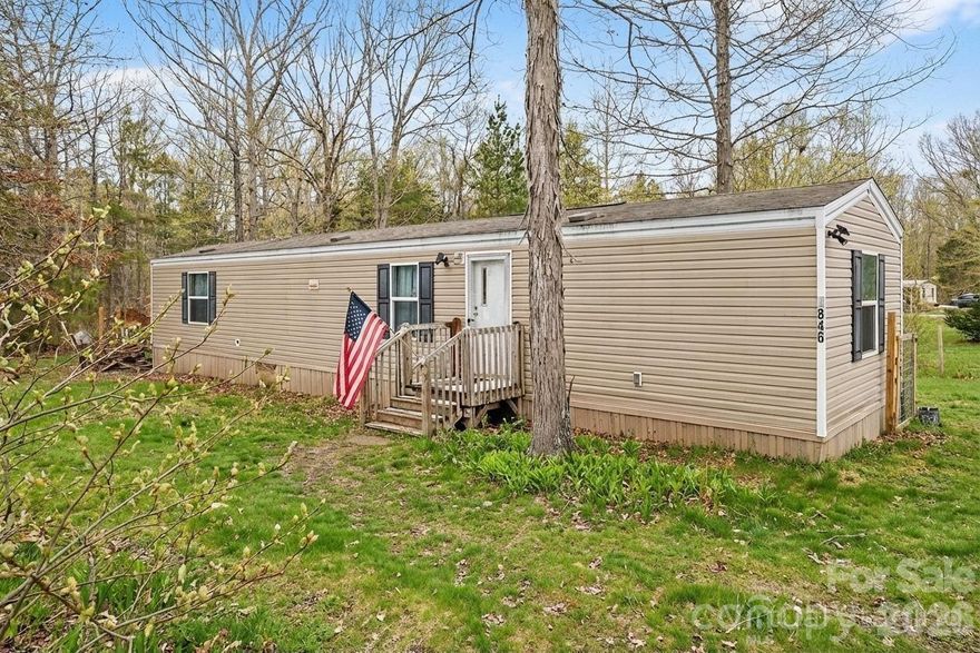 Tucked away on a peaceful one-acre homesite in York, this charming 2019 manufactured home offers a wonderful opportunity for comfortable country living with modern conveniences. Surrounded by mature trees and set on a level, partially fenced lot, the setting provides both privacy and space to enjoy the outdoors. Inside, the home features an inviting open layout with vinyl plank flooring throughout and a spacious living area that flows easily into the kitchen. The kitchen is well-equipped with ample cabinetry, durable countertops, and appliances including an electric range, dishwasher, and exhaust fan, making everyday living and meal prep a breeze.

With two bedrooms and two full bathrooms, the floorplan is functional and comfortable, including a private primary suite and additional bedroom ideal for guests, a home office, or family use. A dedicated main-level laundry room adds convenience, while the heat pump and central air ensure year-round comfort. Outdoor living is enhanced by a deck perfect for relaxing or entertaining, and the property includes well and septic already installed. This home blends affordability, space, and a quiet rural lifestyle all within reach of York amenities.
