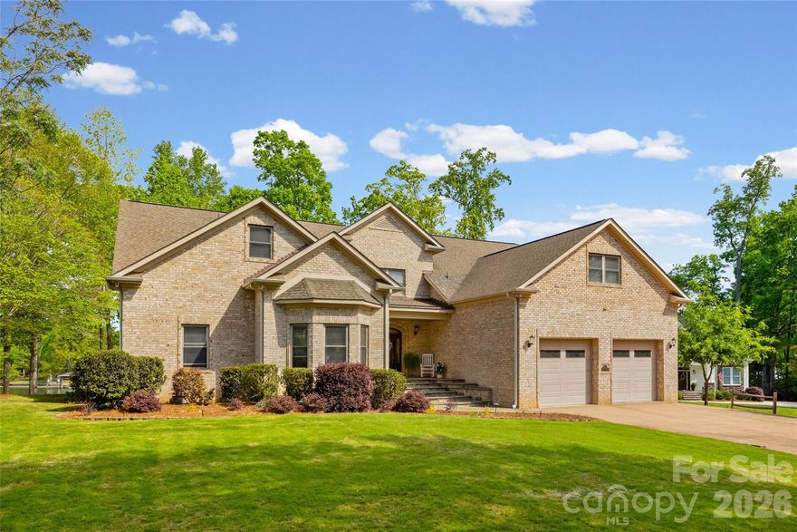 Welcome to lake living at its finest on highly sought-after Johnson Road in Clover on beautiful Lake Wylie! This exceptional .69-acre flat retreat features a rare 149 feet of shoreline lined with Firecracker Azalea, paired with breathtaking panoramic lake views. Enjoy stunning sunrises from the kitchen windows and unforgettable sunsets from the back patio, creating the perfect backdrop for everyday living.

Designed with flexibility in mind, the layout is ideal for multi-generational living or room to spread out, offering space and privacy for everyone. Inside, you’ll find 9’ ceilings and beautiful engineered hardwood floors that add warmth and timeless character throughout the main living areas. The bright, airy kitchen is thoughtfully appointed with double ovens, a gas stovetop, soft-close drawers, and even a built-in trash compactor—perfect for both everyday use and entertaining. The adjacent great room showcases a beautiful custom gas fireplace, perfectly paired with built-in floating shelves for a clean, modern look.

Enjoy seamless indoor-outdoor living with three sets of French doors located in the primary bedroom, dining room, and family room, two of which feature retractable screens for added comfort and convenience.

The spacious primary suite offers private access to the back patio, multiple closets, and a luxurious en-suite bath with tall ceilings, a steam shower, and soaking tub.

Additional highlights include an oversized laundry/keeping room with sink and abundant storage, as well as a whole house fan for added efficiency and comfort.

Step outside to the covered Trex patio and take in peaceful views and a true waterfront lifestyle. The backyard showcases lush Zoysia grass both front and back, along with a custom fire pit perfect for cozy evenings by the lake.

The double-decker DEEP WATER dock is designed for both fun and function, complete with a slide, boat lift, sundeck, and floating dock. The dock offers ample storage with two deck boxes and two storage closets—perfect for keeping all your water toys and gear organized. The dock is fully permitted and truly a must-see.

Whether you’re looking for a full-time residence or a lakefront retreat, this property offers the perfect blend of comfort, thoughtful upgrades, functionality, and unforgettable views.