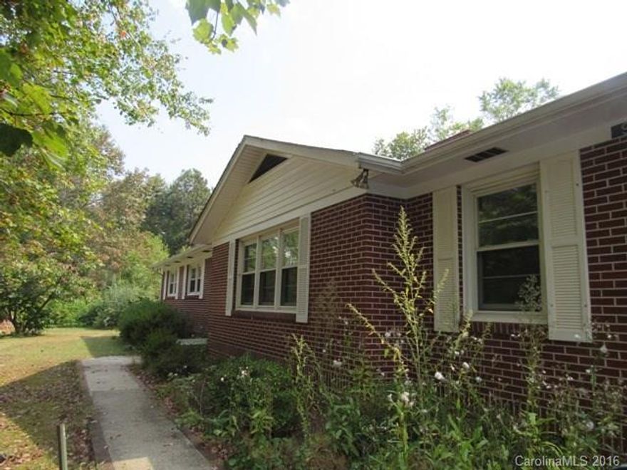 WELL BUILT BRICK HOME IN CITY LIMITS OF  Spruce Pine.  Home consists of entry foyer, formal living/dining room, combination family room and kitchen, three bedrooms, two baths & nice sun room with attached deck.  Full Basement  with interior & exterior entrance.  Several outbuildings for storage or work shop area.  Covered area to store wood for furnace & stove inserts. Unrestricted and room for garden, etc.