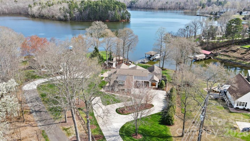 This is one of those rare Lake Wylie properties that seldom come available in this condition that offers the lake-house amenities you have been searching for. All you need to bring are your sunglasses and bathing suits because the rest is move-in ready. It is time to enjoy lake life in 2026.

Set on a perfectly manicured lot overlooking a deep-water cove, this home enjoys beautiful views across to Daniel Stowe Botanical Gardens and the Carolina Thread Trail. Inside, you will find four bedrooms and four full baths, along with a stunning family room, kitchen, breakfast area, and second great room, all designed to take full advantage of the water views.

The primary suite features a vaulted ceiling and a custom ensuite bath with a walk-in shower and jetted tub, again with amazing lake views. Upstairs, there is the 4th BR/  bonus room that can serve as an additional bedroom or flexible living space.

From the moment you walk in, you will be impressed by how spotless and exceptionally maintained this home is. Step outside and enjoy the covered back porch, resort-style pool and spa, tanning ledge, custom water feature, and both poolside and lakeside outdoor fireplaces. Boat dock, with boat lift for jet skis or pontoon.  Additional boat lift with no height restrictions for larger center consoles or wakeboard boats.  
This is a must-see property. Come experience life on Lake Wylie with convenient access to Charlotte Douglas International Airport, Uptown Charlotte, local hospitals, Gastonia, Belmont, Rock Hill, plus abundant shopping and dining options. This is truly one of the best opportunities to enjoy the Lake Wylie lifestyle!  Come ready to be impressed!