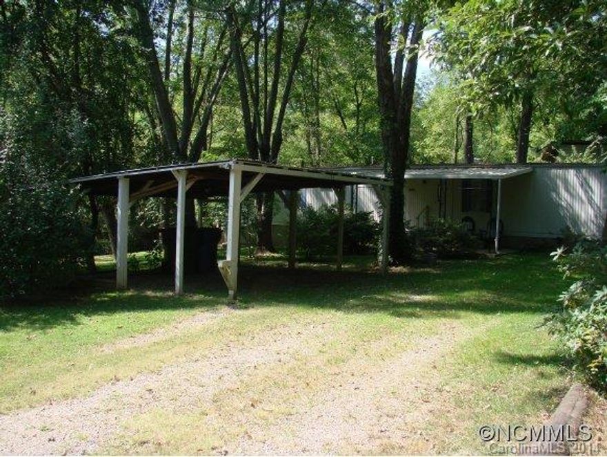1 bedroom singlewide (easily made back into a 2BR) on nice level lot.   Flowing creek on the property, fenced back yard and storage building.  Nice covered front porch and 2 car carport.