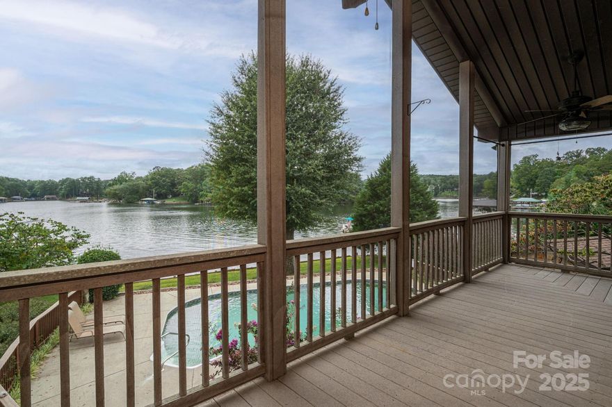 IDEAL FOR MULTIFAMILY LIVING.  Welcome to your dream retreat! This stunning lakefront lodge is nearly 3700 square feet. The living space is perfect for entertaining or multigenerational living. Enjoy breathtaking sunrise AND sunset views from the screened porch or pool deck. Relax in your private pool or head down to your private dock. Inside you will find two living rooms, two kitchens, and bedrooms on both levels.  The upstairs primary suite is absolutely massive and the amount of storage in this home is unheard of. The upstairs kitchen features custom made tile backsplash.  The solid wood custom doors throughout illustrate perfectly just how well the sellers have cared for this property. The outside mature landscaping is easy to maintain with the irrigation in the front and backyards that feeds from the lake.  This isn't just a house, it's a lifestyle of vacation.