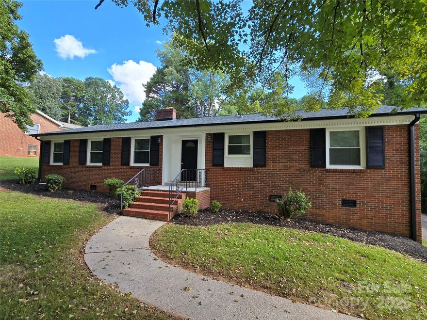 LOCATION LOCATION LOCATION!!  This lovely one level brick ranch in NW Hickory NC is in the ideal location for commutability or to lots of local attractions.  Minutes away from the Hickory Crawdad's Stadium, lots of fast food and casual dining, the downtown area, plus much more. This home boasts large rooms with neutral colors, lots of modern updates, and laminate flooring throughout. The kitchen is beautifully updated with lots of cupboards and plenty of prep space.  The wood burning fireplace was swept out recently and is ready for winter. The roof on the house, carport , and outbuilding were all replaced in 2024. New gutters with leaf guards in 2024. The lot is uniquely shaped, offering current street access to 12th Ave, but a new owner could create access to 10th St Pl Cir NW easily for a second driveway if needed.