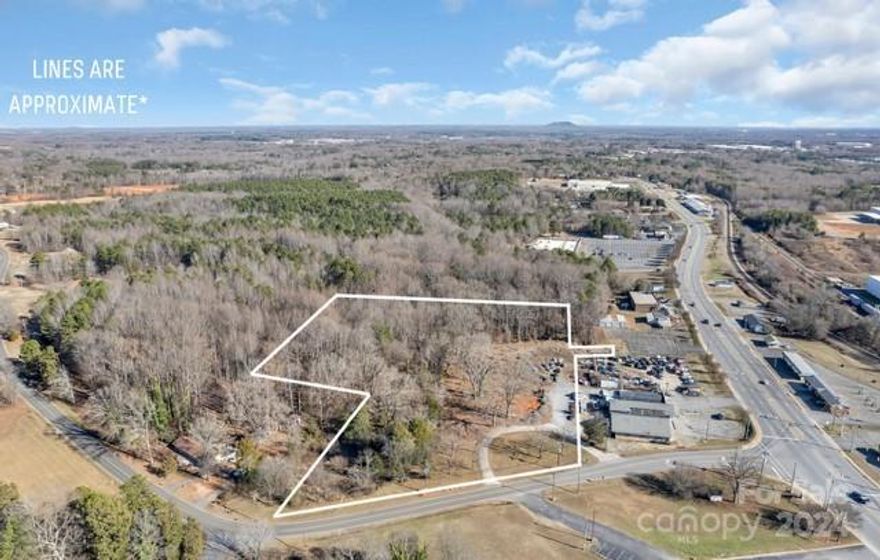 6.96 wooded Acres of prime commercial zoned property with 424' of road frontage.  Conveniently located in the city limits of Bessemer City and easily accessible from both Exits 13 & 14 of Interstate 85.  Perfect location for either a shopping center or a new housing development.  City water and sewer are available with tap fees.   No sign on property due to seller's request.