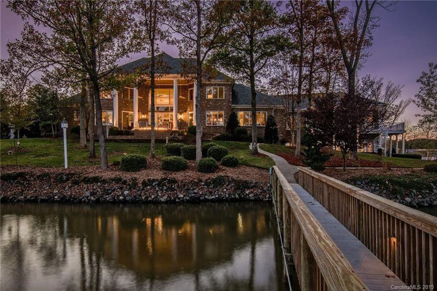 This extraordinary waterfront home is situated on 1.21 acres with breathtaking wide channel views. The spacious property boast over 10,000 square feet and has a wonderful flow for entertaining. Comfort and security are ensured throughout, with top quality materials such as mahogany hardwood floors, stain glass windows, and state of the art, security system. There is attention to detail with every turn in this stunning home. 8 car garage with two docks and boat lift, and remote gated entry.