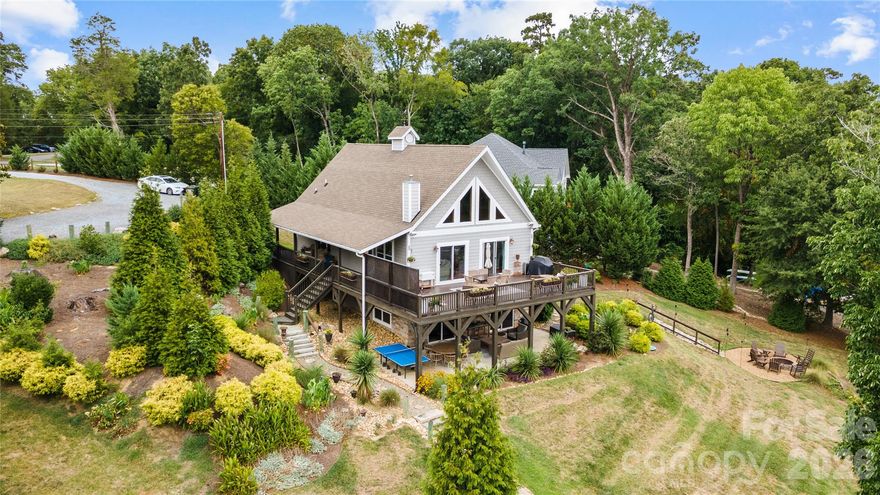 Welcome to this fully furnished waterfront home on Lake Wylie offering the kind of lifestyle buyers search for but seldom find. Blending relaxed lake living with polished interior finishes, generous entertaining space, and turnkey convenience. From the moment you arrive, the setting feels like a retreat, with a wraparound porch, covered deck, covered back patio, and long lake views that make everyday living feel like a getaway.
Inside, the main level is warm and inviting, anchored vaulted wall of windows, a gas-burning stone fireplace, and an updated kitchen designed for gathering. The kitchen features an island, stainless steel appliances, and a gas cooktop, giving buyers the function they want and the style they expect in a waterfront home. The layout offers excellent flexibility with a laundry room that includes the washer and dryer, sink and storage. The stunning primary suite with a walk-in closet and five-piece bath offers a nice retreat. A second bedroom and full bath round out the main level.  Upstairs, a spacious loft and full bath create the perfect bonus area for guests, or additional lounge space. The fully finished walk-out basement expands the home’s livability with a true entertaining setup, including a wet bar with sink and two beverage refrigerators and an additional bedroom and full bathroom. Enjoy a bunk room with built-in bunk beds, and a flex room that can easily serve as overflow guest space. Outside, the property captures the best of Lake Wylie waterfront living with an outdoor shower, fire pit by the water, paddle board launch area, and your own private dock creating - an effortless connection between the home and the lake. This is the kind of property that works beautifully as a primary residence, luxury getaway, income producing rental, or furnished second home near Charlotte. The location adds even more appeal. The home sits in Charlotte’s sought-after Lake Wylie area, with access to outdoor recreation at McDowell Nature Center and Preserve. This property delivers the lakefront lifestyle buyers want with the convenience of being just outside the city.