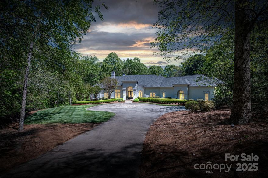 Welcome to your private retreat just minutes from SouthPark and Quail Hollow Country Club. Set on over 2 acres of beautifully landscaped and fully fenced grounds, this custom-built estate offers luxury, privacy, and timeless elegance. A circular drive leads to a 3-car garage, with upper and lower terraces, a sparkling pool, and incredible curb appeal. Inside, the expansive floor plan features a main-level primary suite with a morning bar, two custom walk-in closets, and a renovated spa-style bath with a marble shower, whirlpool tub, and dual vanities. The gourmet kitchen boasts marble countertops, high-end stainless steel appliances, a center island with seating, and a bright breakfast area that opens to the keeping room with a dramatic stone fireplace. Each secondary bedroom offers an en-suite bath and spacious closet, ensuring comfort for family or guests. This exceptional home combines refined craftsmanship with modern updates—perfect for entertaining or peaceful luxury living.