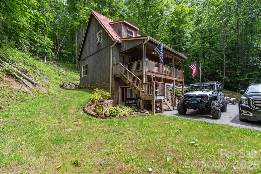 Seated on nearly 8 acres in the heart of the Blue Ridge mountains in Bakersville NC just outside of Spruce Pine, this property offers some compelling reasons to take a closer look. There is just over 2000 sq ft of living space, with a bed and bath, and flex area/ game room/ man cave in the basement, master suite on the main level, two story ceiling in the dining room, and an attractive loft area. Two porches off the master bedroom and the main living offer a view of the foothills below Roan Mountain. With attractive stone landscaping, board and batten siding, hardwood floors, and hickory cabinets, this home is a true mountain cabin retreat. A garage shop near the house offers a great spot for a workshop, storage, hobbies and more. A home inspection and survey are in hand.