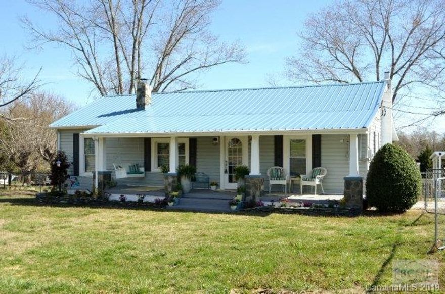 Wonderful updated 3BR/2BA cottage situated on 1.25 acres in the heart of Glen Alpine! Fully fenced front and back yard and partially fenced side yard make great play space for children or pets and provide a garden area. Inviting covered front porch has a cozy porch swing and is accented by rock columns and beautiful landscaping. Bright, spacious living room has original hardwood flooring, electric fireplace with outlet above for television.  Beautiful eat-in kitchen features new, tall cabinetry, countertops, farmhouse chic fixtures, and dark stainless dishwaher, range/oven.  Guest bath offers large walk-in shower, designer vessel sink and bead board/tile accents.  Spacious master bedroom  has a large closet and master bath provides dual vanities, shower/tub combo.  Workshop/outbuilding has electrical service and pull down stairs for attic storage. Circular drive with detached carport. Convenient to schools, shopping, I-40.  New heat pump in 2017.