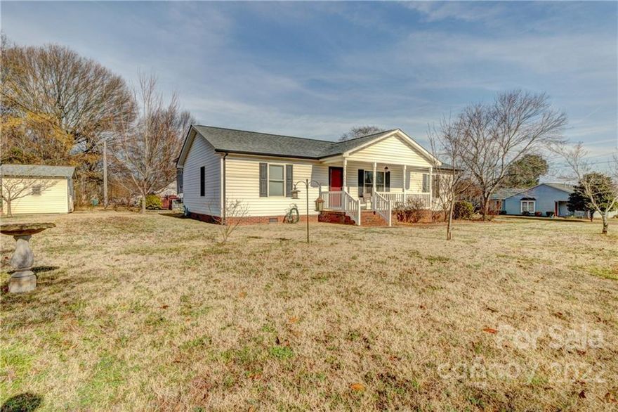 This well maintained 1266sqft home on a corner-lot is perfectly located, and comes with all of the appliances! This home had a fire in 2011 and insurance was claimed. The home was rebuilt from the foundation up. Vinyl wood flooring throughout the home and carpet in the bedrooms. The soft close kitchen cabinets match the bathrooms. Exterior features include an outbuilding, covered front porch, a firepit surrounded by pavers, and a large 2 car carport. Welcome home!