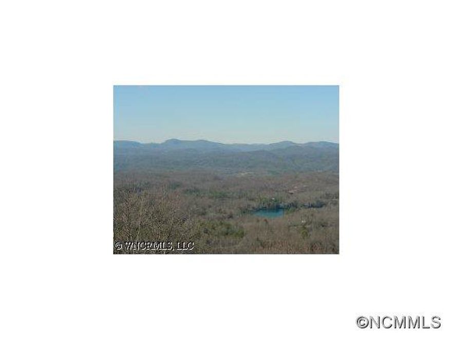 PREMIER BUILDING LOT WITH OUTSTANDING VIEWS OF DISTANT MOUNTAINS AND ALSO A VIEW OF THE LAKE. ONE OF THE BEST VIEW LOTS STILL AVAILABLE IN CONNESTEE FALLS.