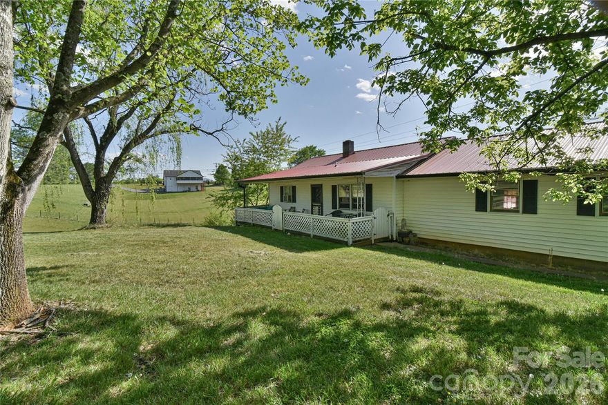 Great home with a barn and outbuildings on a stunning 35± acre property offering everything you’ve been searching for.  The home features a vintage style with 2 bedrooms, living room and kitchen on the main level.  Downstairs there is another bedroom, family room and an area that could be a second kitchen.  This would allow you to live on one level and rent out the other if you wanted.  The property features rolling, usable land with breathtaking long-range mountain views, a small stream winding through the property, and a peaceful pond.  Multiple ideal building sites provide the perfect setting to create your dream estate, whether you’re seeking complete privacy or sweeping views. Or keep it the way it is with the existing home, barn and outbuildings for a working homestead, hobby farm.  With Open Use County zoning and a prime location just minutes from Asheville and Weaverville, this property offers unmatched flexibility and convenience. The possibilities here are truly endless.  The possibilities here are truly endless.  Please make an appointment to see the property and do not disturb the tenants of the home.
