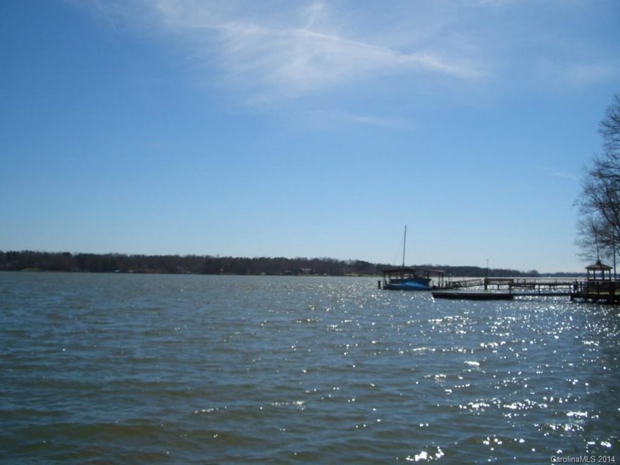 Spectacular main channel views of LKN, covered low maintenance dock, boathouse w/ramp, multi levels of outdoor entertaining space, 3 car garage has additional storage above, open light and bright plan with a wall of widows to enjoy the lake views, master suite enjoys a loft entrance with private office, enormous walk in closet, master bath w/zero entry shower, master BR fireplace and lake view balcony, 2 additional FP's & game room on lower level. BRAND NEW WELL AND SEPTIC FOR A 4 BEDROOM HOME