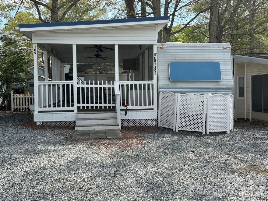 Escape to Badin Shores Resort with this charming one-bedroom camper situated on a flat, deeded lot in a gated waterfront community. Enjoy relaxing on the covered porch or take advantage of the resort-style amenities just steps away—including the pool, basketball courts, putt putt, fishing pond, and more. The level lot provides ample parking for vehicles, golf carts, and even a boat. A spacious storage building is perfect for your lake toys and gear. Inside, you'll find updated LVP flooring and a cozy layout ideal for weekend getaways or extended stays. Whether you're looking for a peaceful retreat or an active lake lifestyle, this property offers it all.