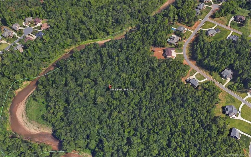 Build your dream home nestled in the middle 8.5 wooded acres complete with your own private beach alongside the streaming waters of Sugar Creek. Perked for five bedrooms. Boundary survey complete (staked). Fully developed (water, cable, electricity). Lot is not subdividable. No livestock. Must be full brick or hard stucco. 3500 minimum sqft. Suitable for walkout basement.  Gated community minutes from shopping, dining and entertainment.