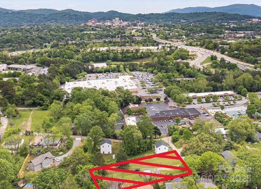 Extraordinary development location with a view of downtown Asheville! These two parcels comprise approximately .76 acres just across the river from downtown. The RM8 zoning allows for a multitude of possibilities, including cottage development. If you are looking for a convenient spot for some form of tiny home community, this may be the one for you. Just far enough off of Patton to escape the noise while close enough to keep all the amenities of Asheville only minutes away. There is currently an older home and outbuilding on the property at 76 Katherine being conveyed at no value; 99999 Emma St. is an unimproved lot. There aren't very many lots still available this close to town!!