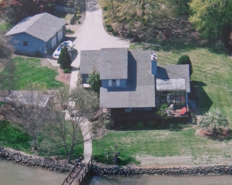 Panoramic views on main channel of Lake Wylie w/ 200 ft of lake front, over 2000 htd living area. Large level cul-de-sac lot. Covered dock w/deep water and boat lift. Covered picnic area w/brick fireplace, 2 car attached and 2 car detached garage w/sep elec meter. Small boat launch. Covered front porch facing Lake. Sunroom w/Jacuzzi, 2 sided fireplace, vaulted ceilings and hardwood floors throughout main level. Master on main. Loft area w/additional beds. York address, CLOVER SCHOOLS!